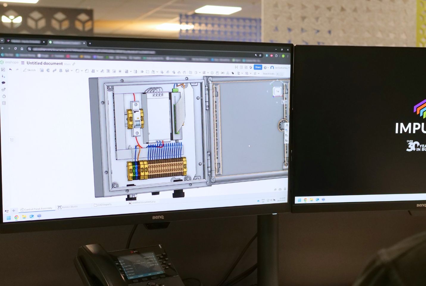 Engineer designing a control panel using CAD software.