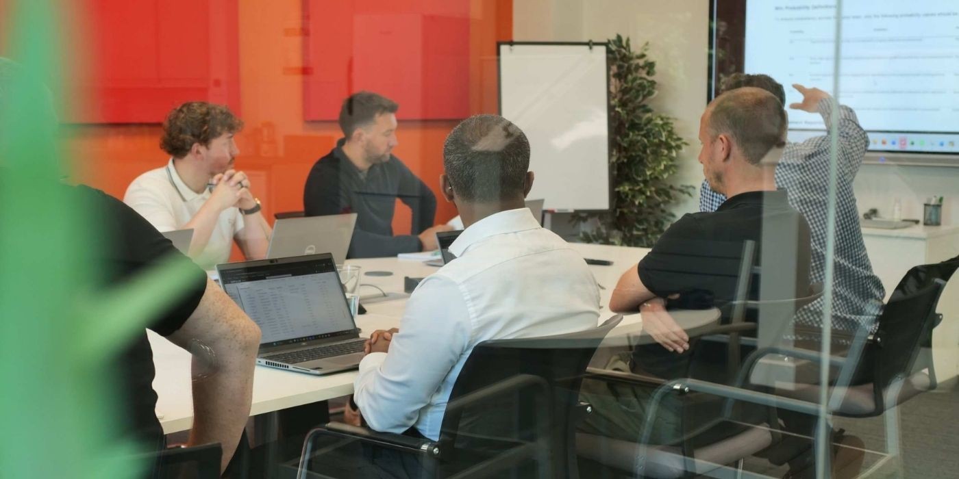 People in a meeting discussing project requirments.